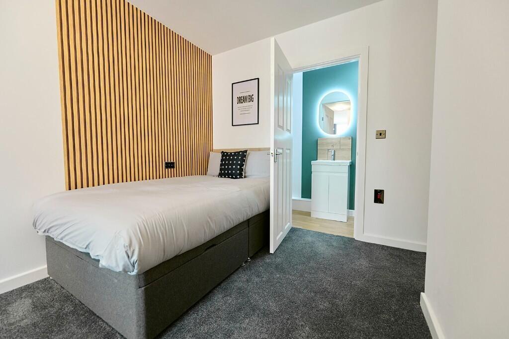 A neat and modern single toilet room featuring ...