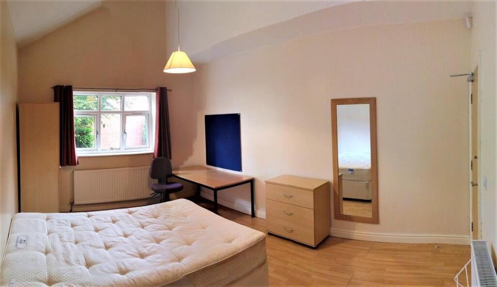 Bright and spacious bedroom featuring a comfort...