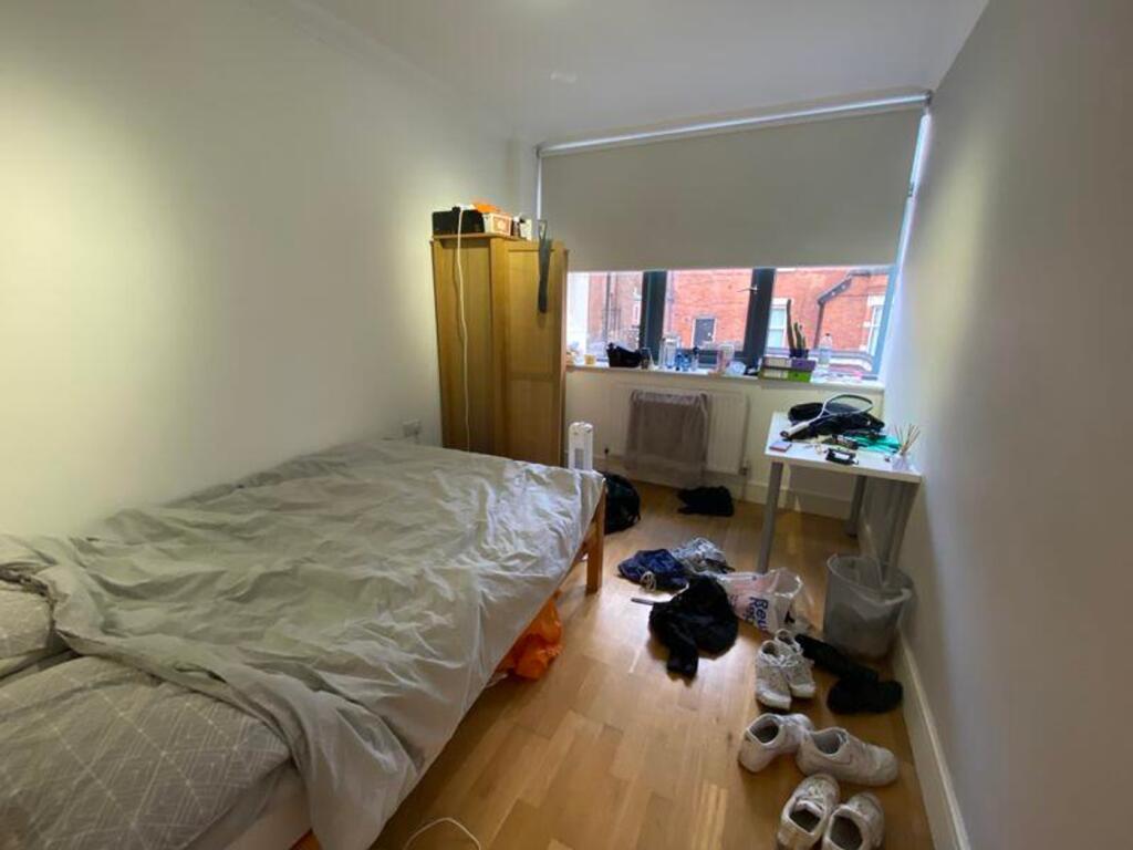 A spacious double bedroom with plenty of natura...