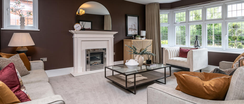 Redrow internal image of spacious lounge with fireplace and bay window at Greenways in Betteshanger