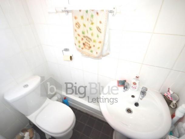 Bright bathroom suite featuring a clean white t...