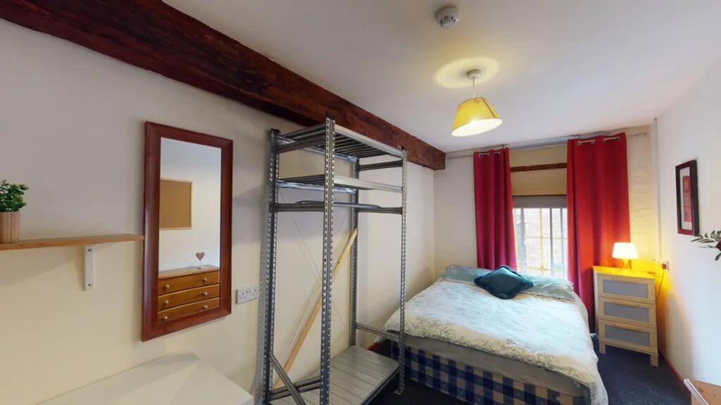 A bright and inviting double bedroom featuring ...