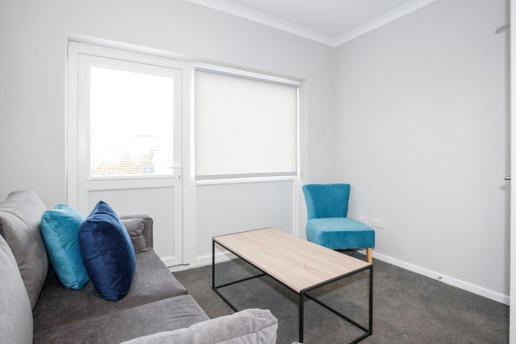 A cozy living room featuring a comfortable sofa...