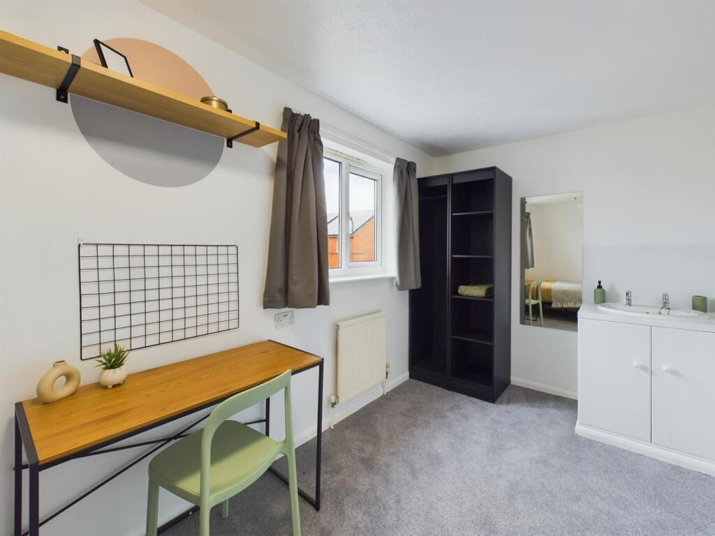 A bright and tidy double bedroom with a study a...