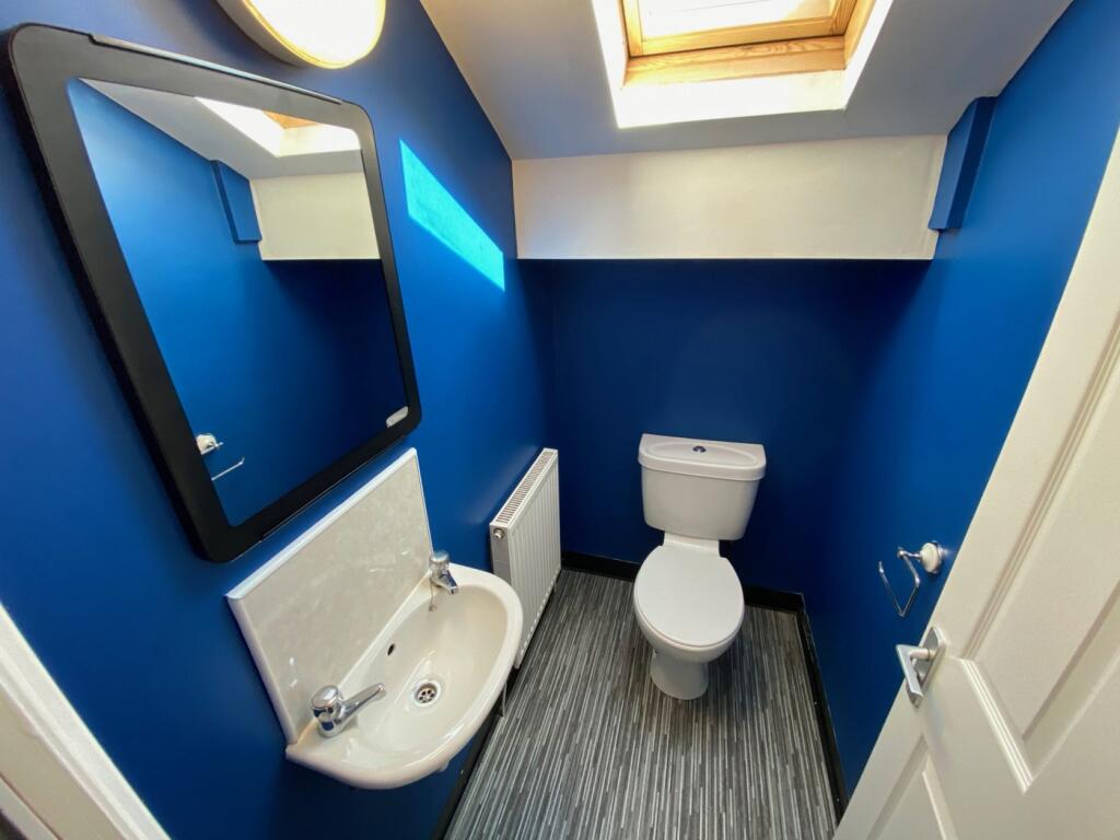 A clean and well-lit single toilet with modern ...