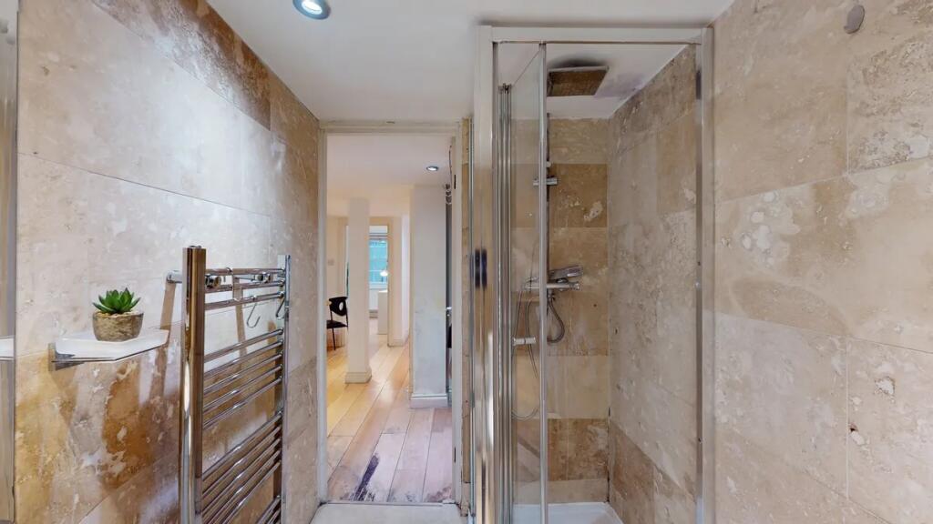 A modern bathroom featuring elegant stone wall ...