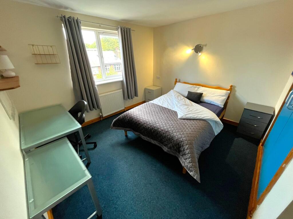 A bright and inviting double bedroom with ample...