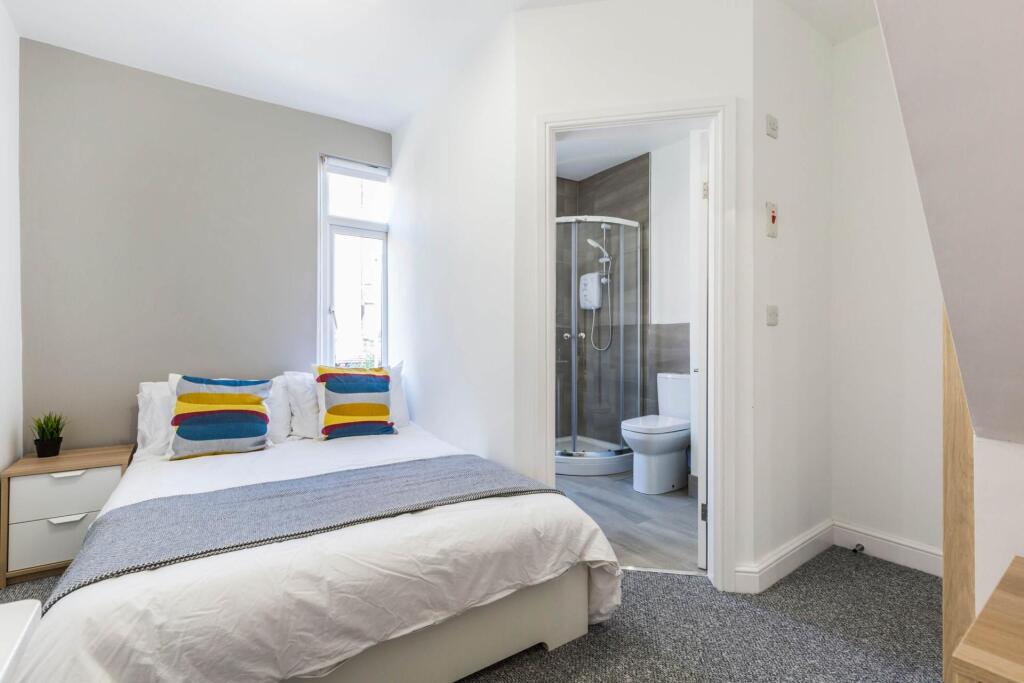 A bright and modern bedroom featuring a double ...