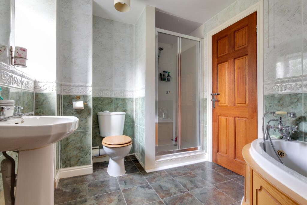 corner bath with over bath shower and separate sho