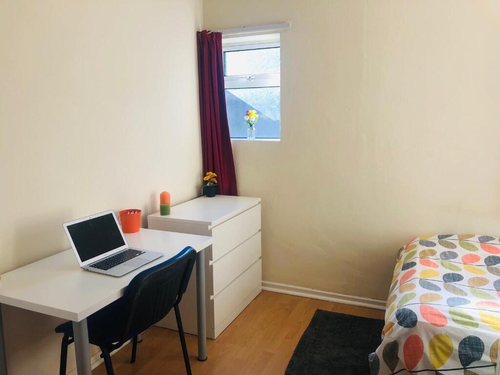 A cozy, bright bedroom featuring a single bed w...