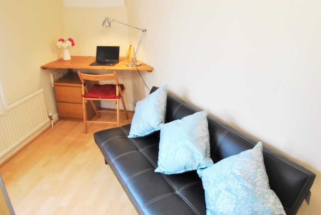 Bright communal lounge with a sleek black faux-...