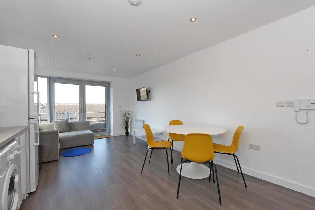 Bright and modern living room featuring a sleek...