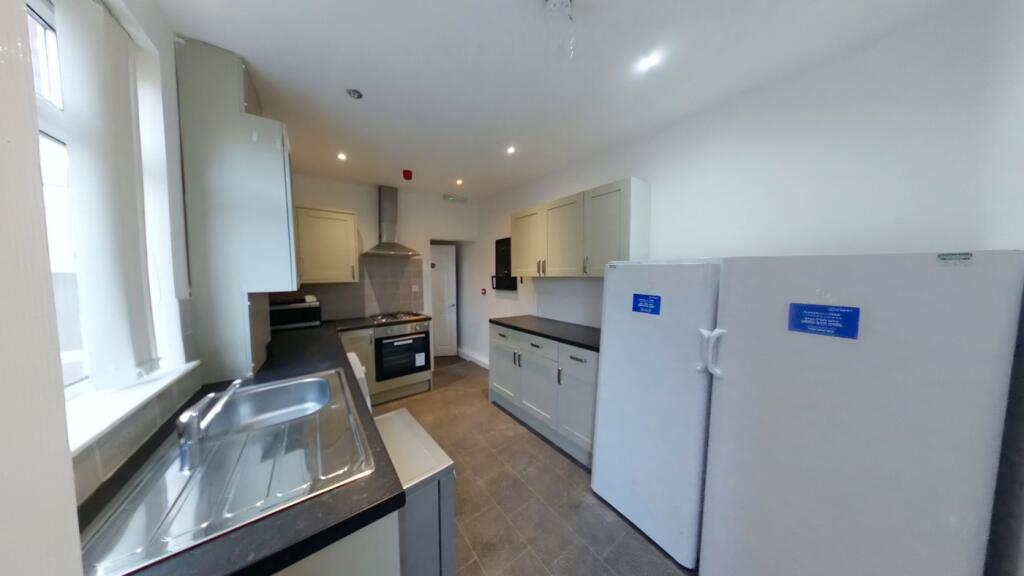 A spacious and modern kitchen featuring ample c...