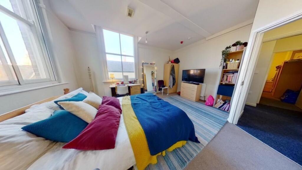 Bright and spacious master bedroom featuring a ...