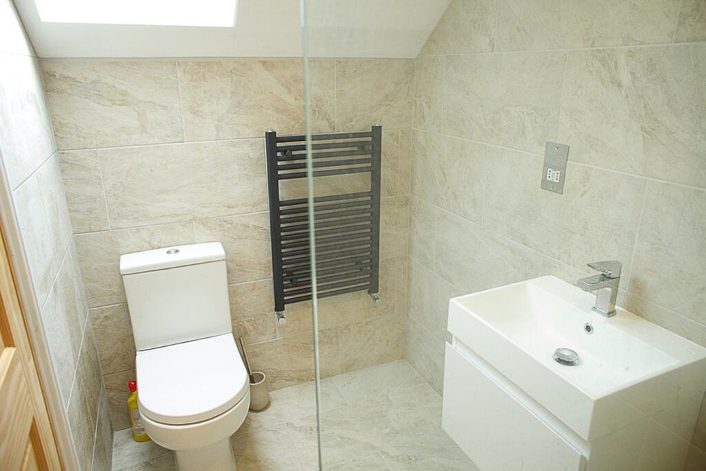 A modern and stylish bathroom featuring elegant...