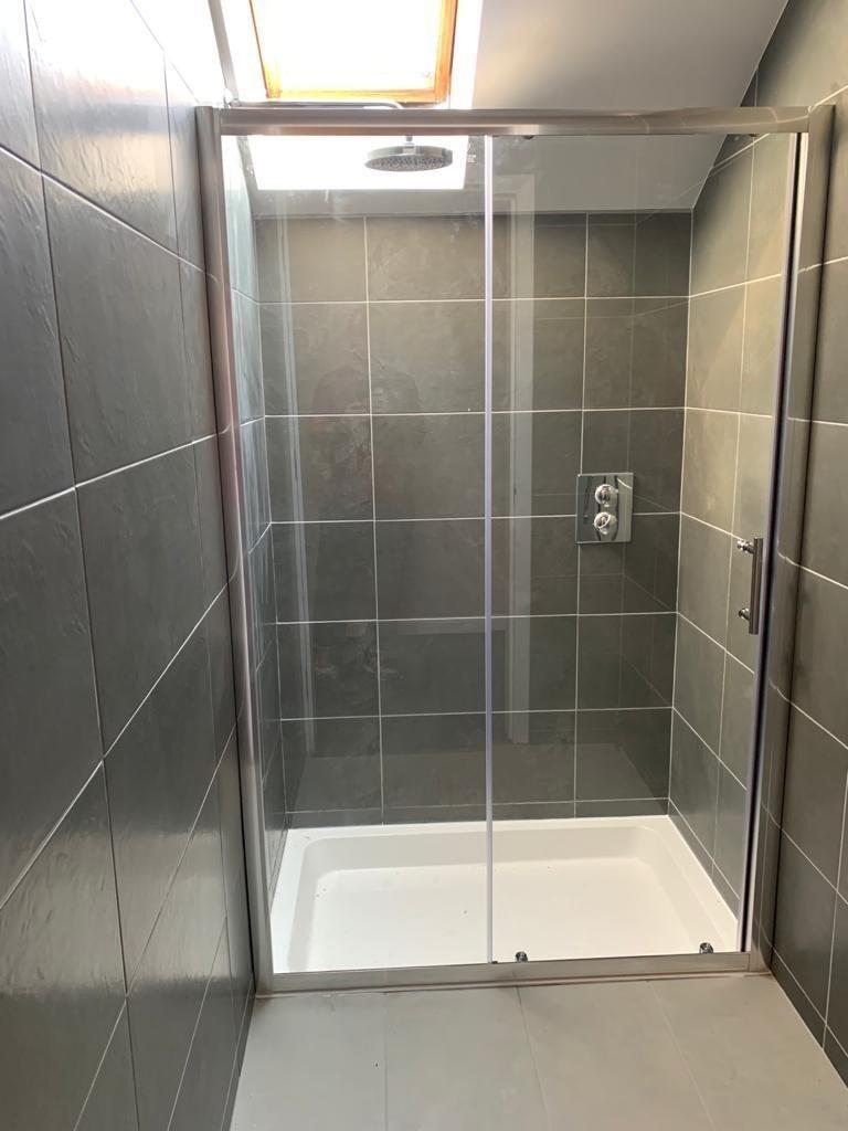 Modern bathroom suite featuring a spacious walk...