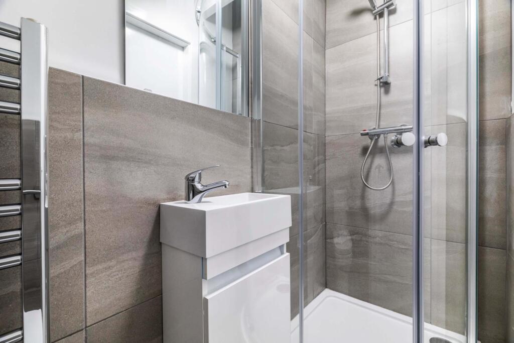 A modern and spacious bathroom with a sleek sin...