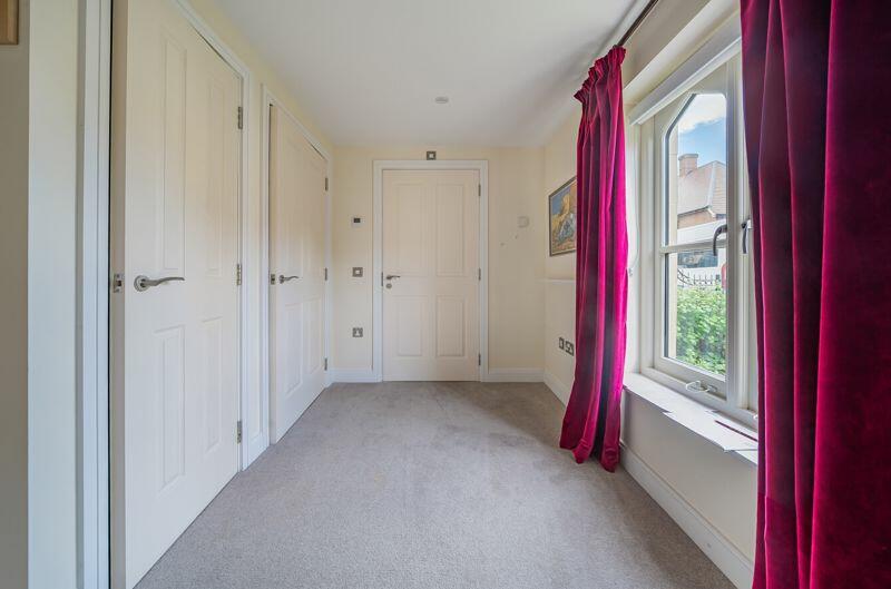 Hallway with storage cupboards