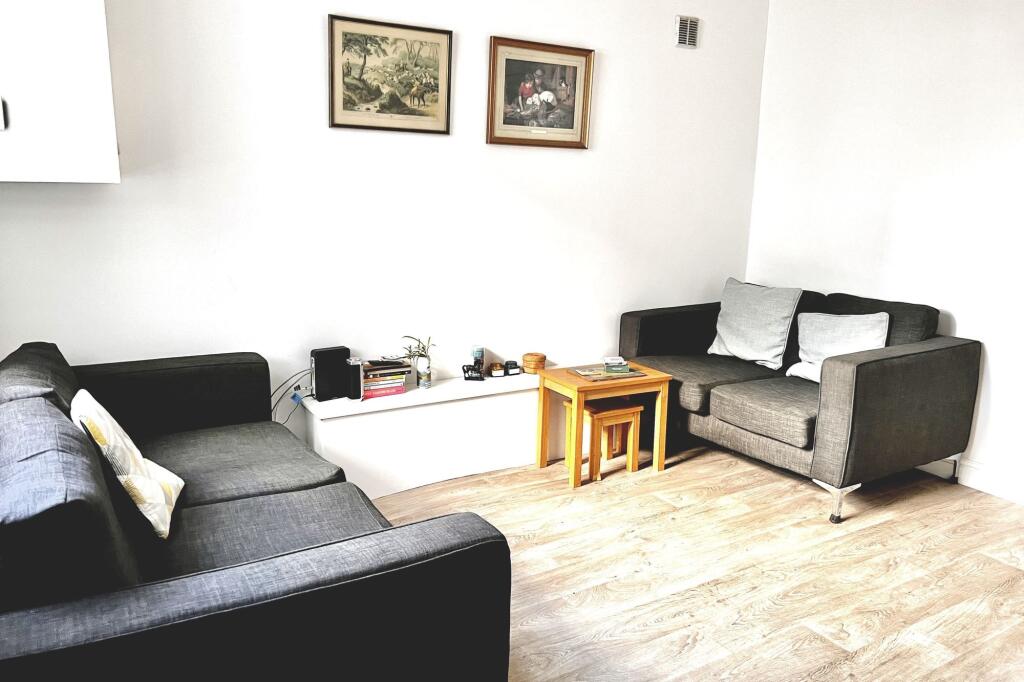 A cozy living room featuring two grey sofas wit...