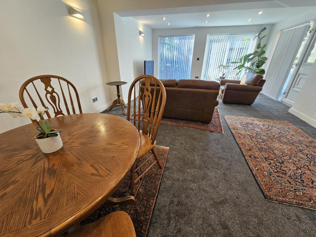 Bright and welcoming living room featuring larg...