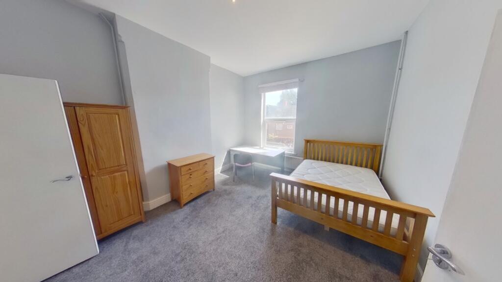 A bright and spacious double bedroom with ample...