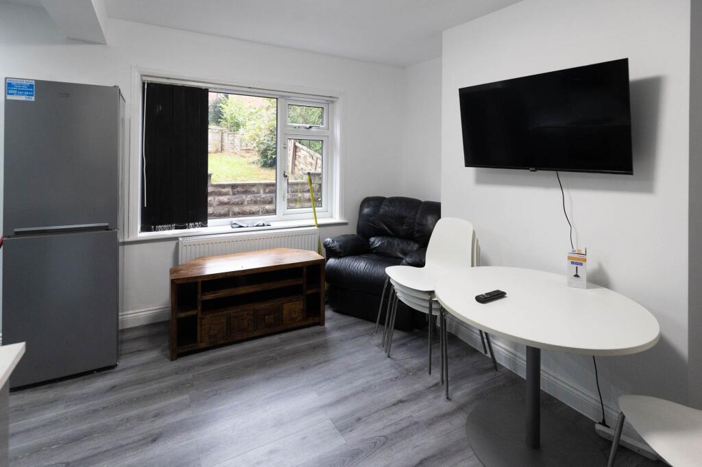 A bright, welcoming living room featuring a lar...