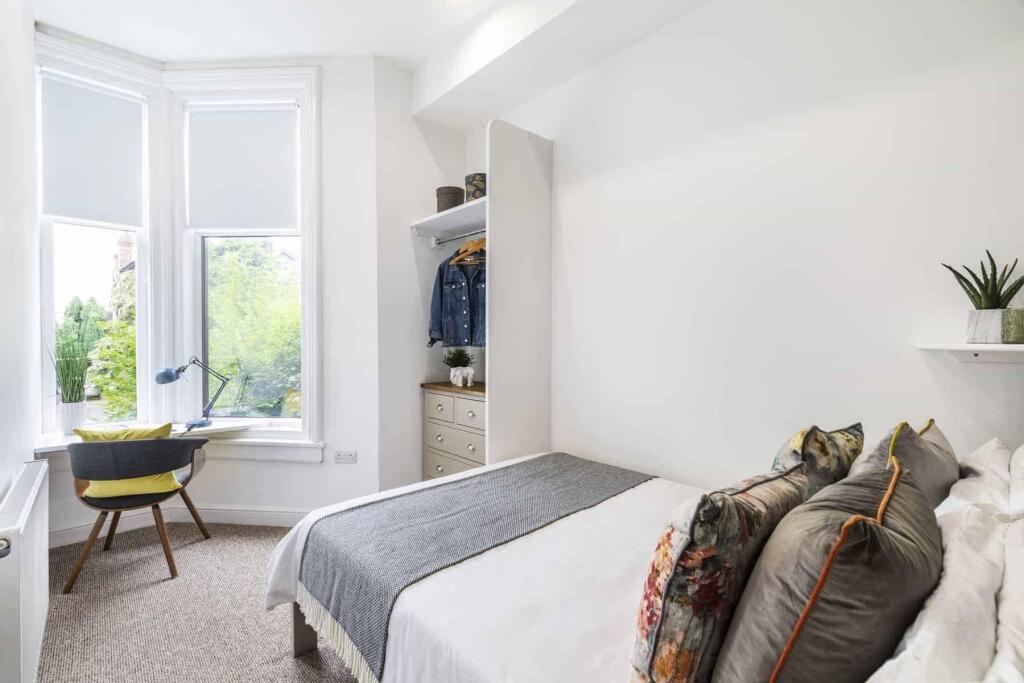 A bright and inviting double bedroom featuring ...