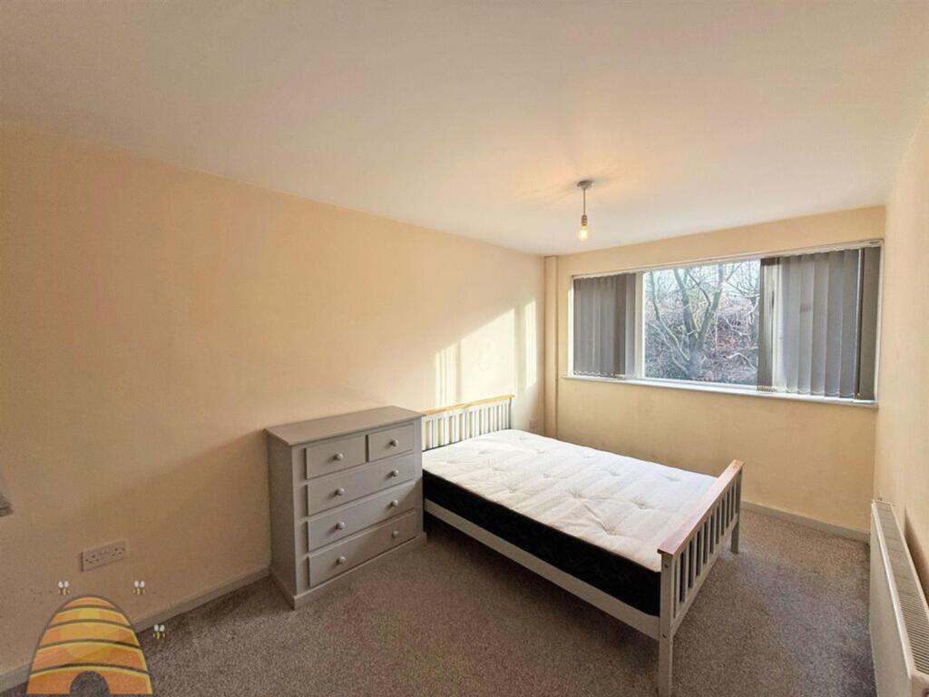 A bright and inviting double bedroom with ample...