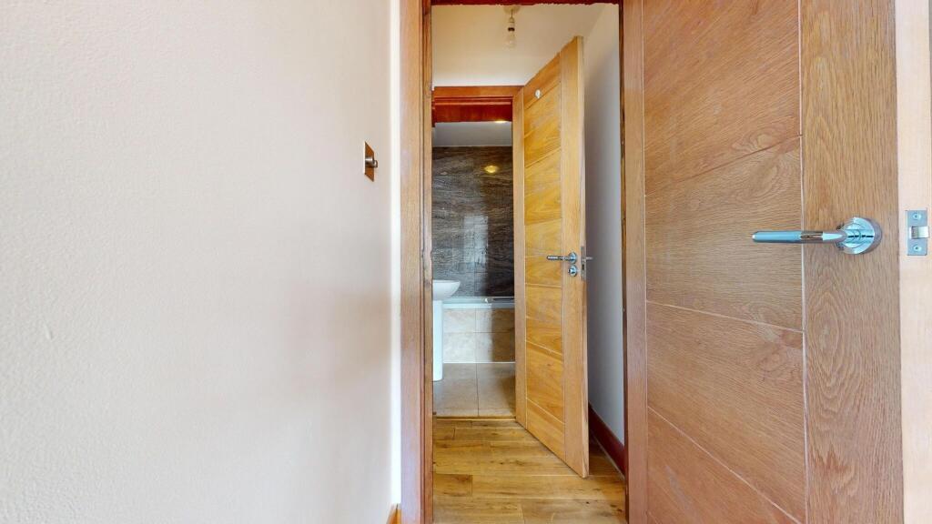 A clean and modern bathroom with a toilet and s...