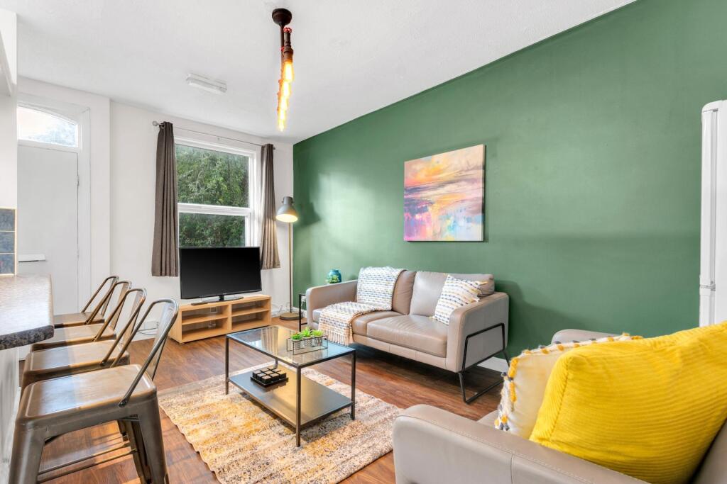 A bright and inviting living room featuring a m...