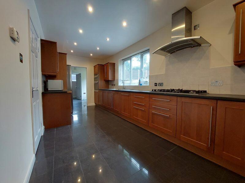 Bright and spacious kitchen featuring wooden ca...