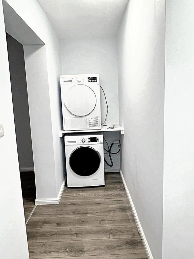 A well-organized laundry area featuring a stack...