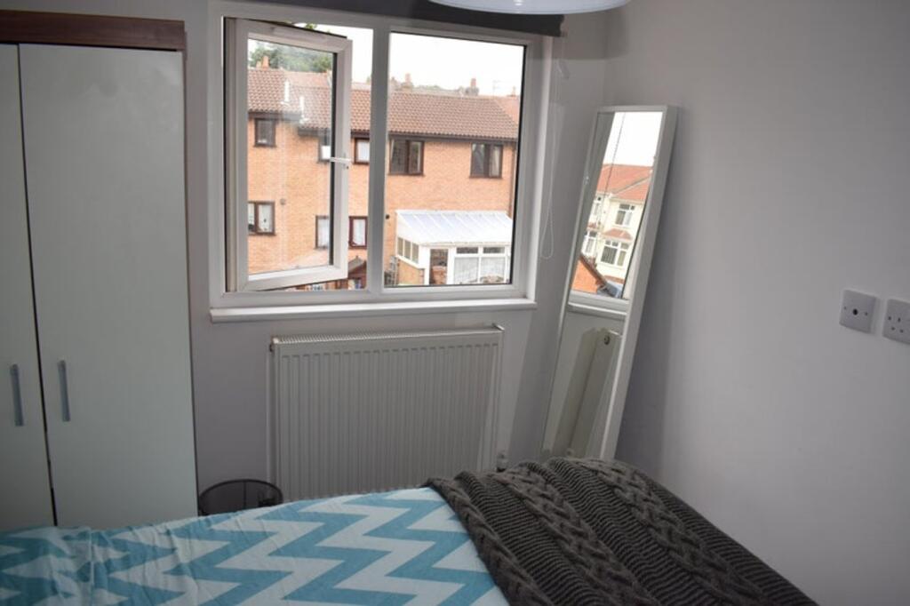 This charming double bedroom features ample nat...