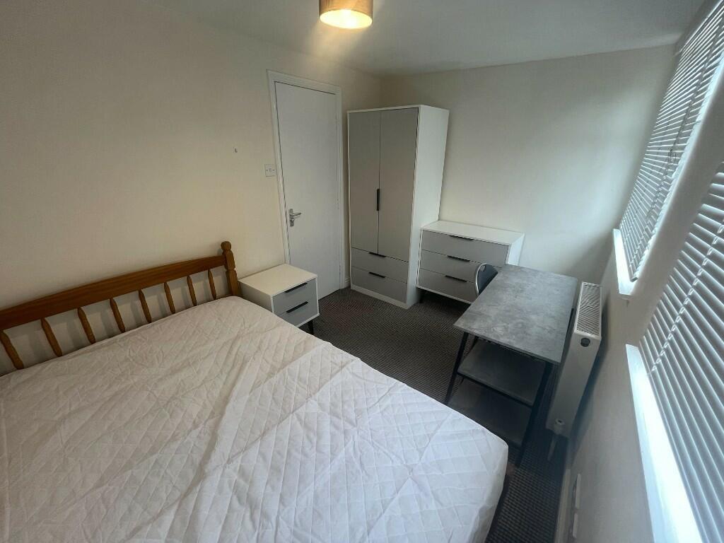 A cozy double bedroom featuring a comfortable d...
