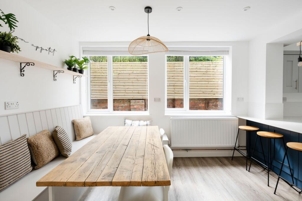 Bright, modern eat-in kitchen with a rustic woo...