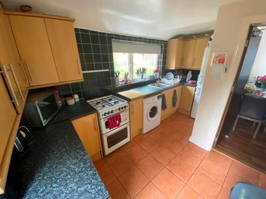 A bright and functional kitchen with ample stor...