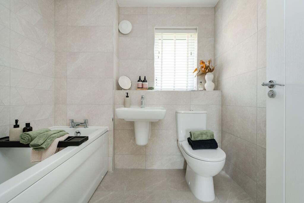 Relax in the stylish family bathroom
