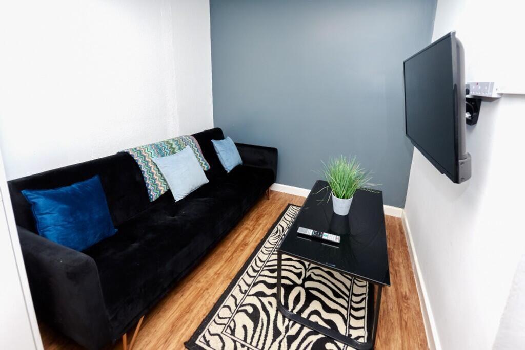 A cozy living room featuring a stylish black so...