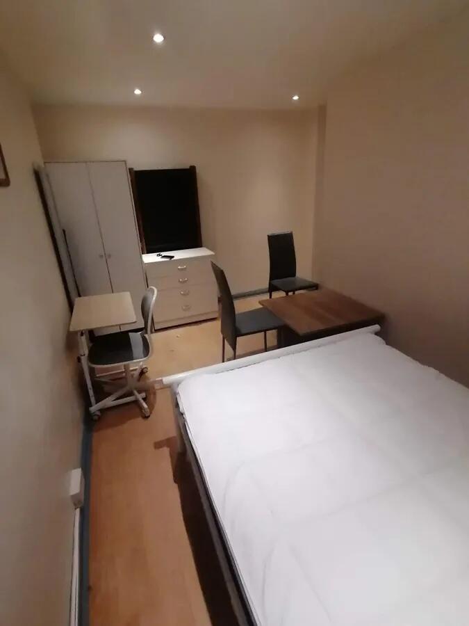 A tidy double bedroom featuring a comfortable b...