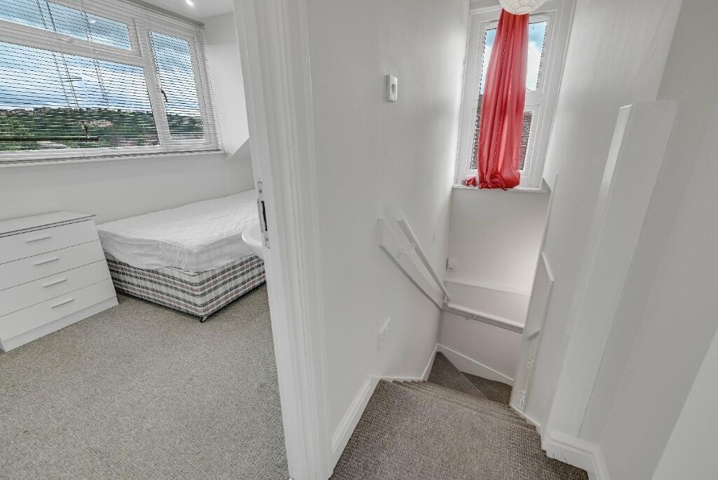 Bright and clean hallway leading to a small but...