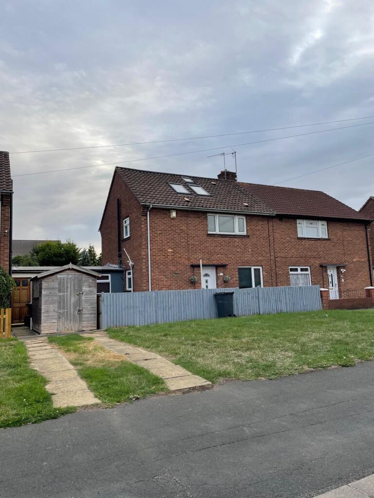 A charming semi-detached brick house with a nea...