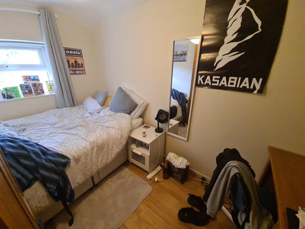 Cozy and compact bedroom featuring a comfortabl...