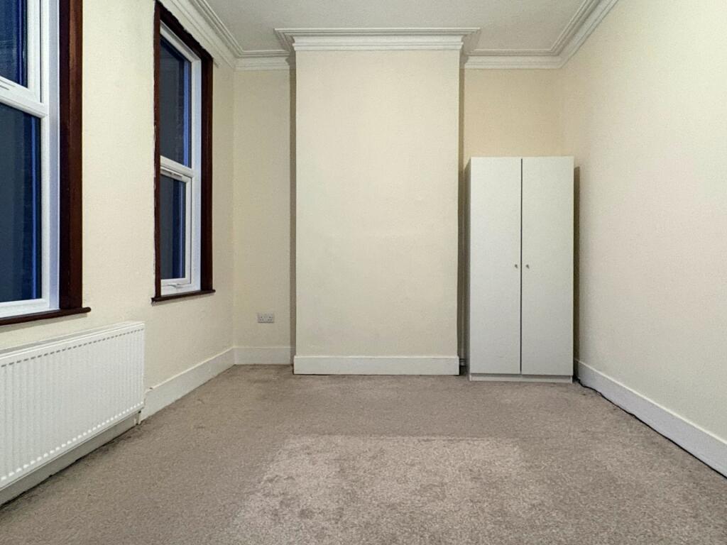 Bright, neutrally decorated single bedroom with...