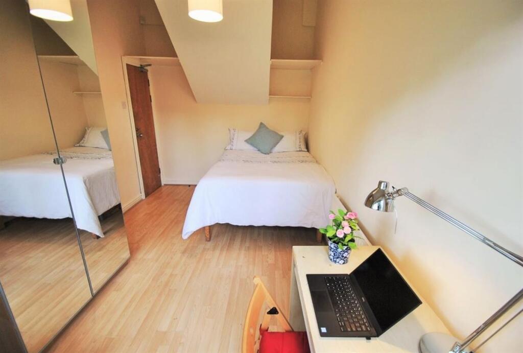 Bright, neatly presented bedroom with a comfort...