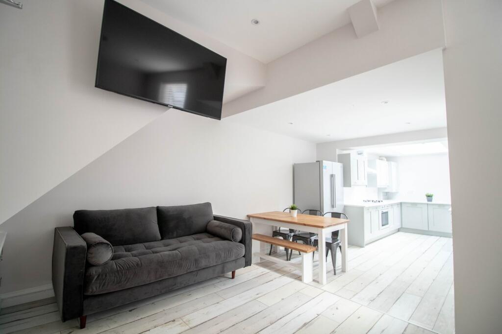 Bright and contemporary living room featuring a...