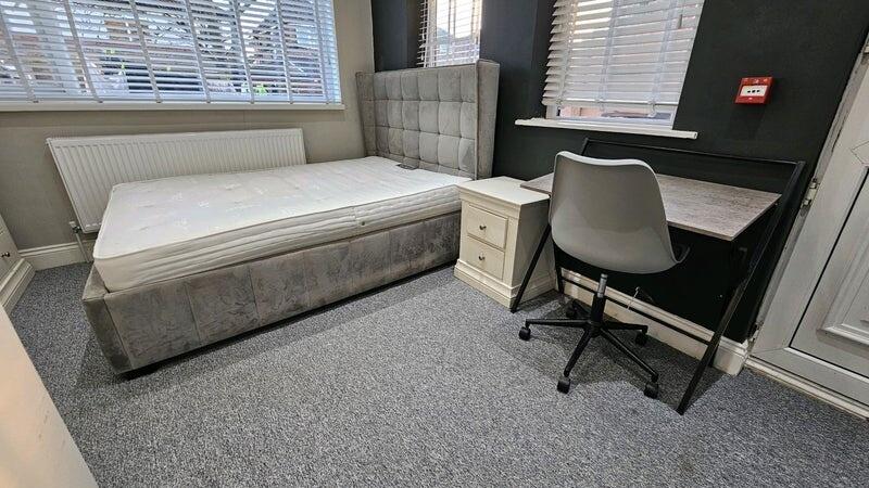 A neat and well-lit double bedroom featuring a ...