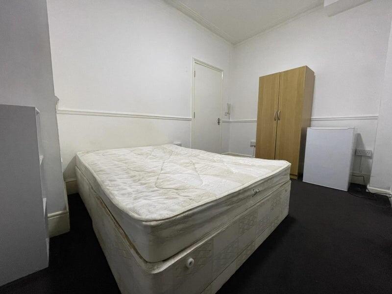 Simple, clean single bedroom with a double matt...