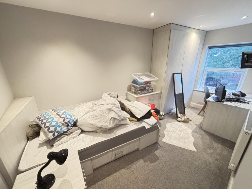 Cozy bedroom with a comfortable single bed, bui...