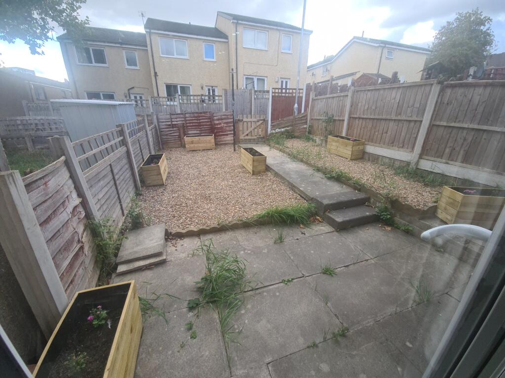 A private, well-maintained garden space with a ...