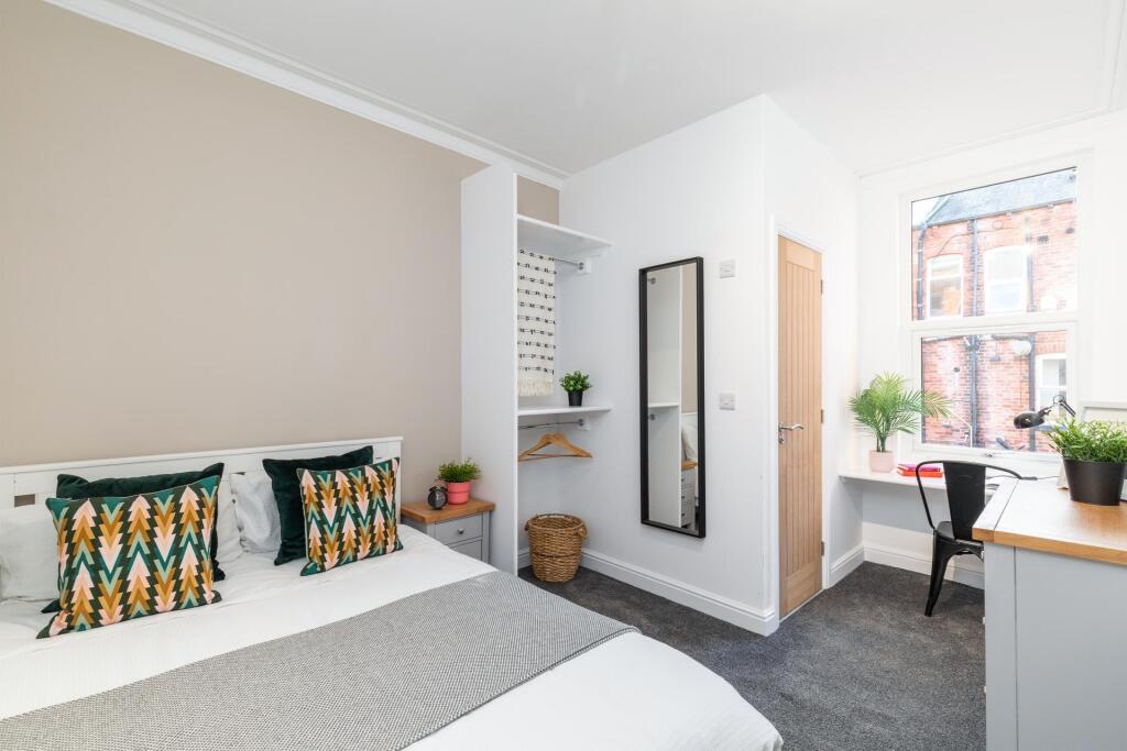 Bright, neatly presented bedroom with a comfort...